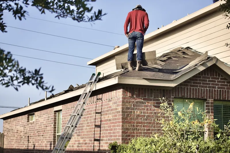 Professional roofer working on a residential roof in The Lakes at Tradition